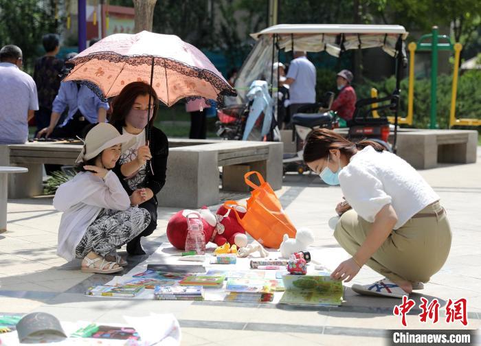 孩子们在家长的陪伴下进行物品交换。　陈康 摄